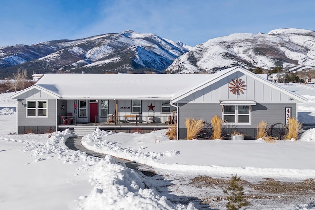 view of front of home with covered porch, board and batten siding, and a mountain view