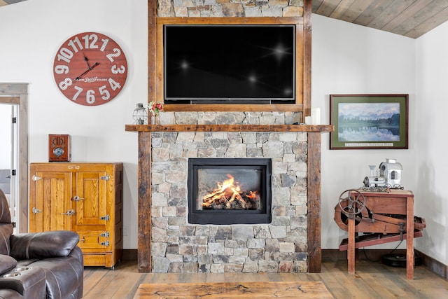 living room featuring a fireplace, lofted ceiling, light wood-style flooring, wooden ceiling, and baseboards