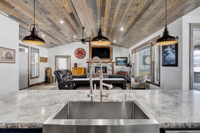 kitchen featuring wood ceiling, pendant lighting, lofted ceiling, and open floor plan