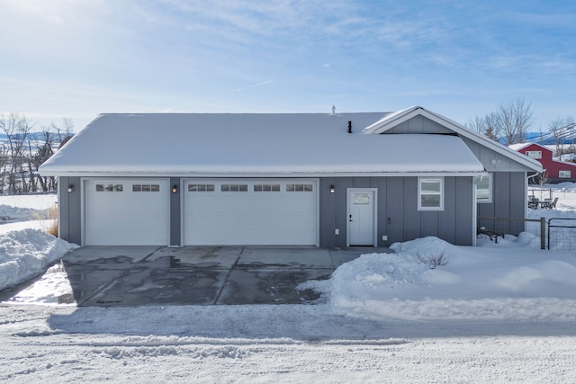 view of front of property featuring driveway, board and batten siding, and an attached garage