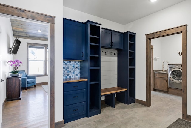 mudroom with recessed lighting, washer / clothes dryer, a sink, and baseboards