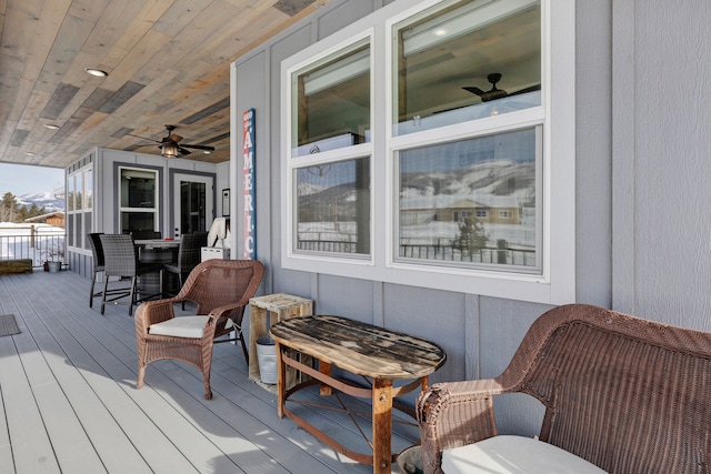 wooden deck featuring a ceiling fan and outdoor dining area