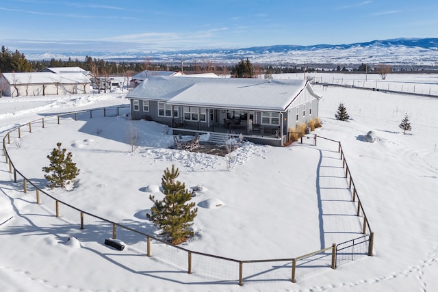 snowy aerial view with a mountain view