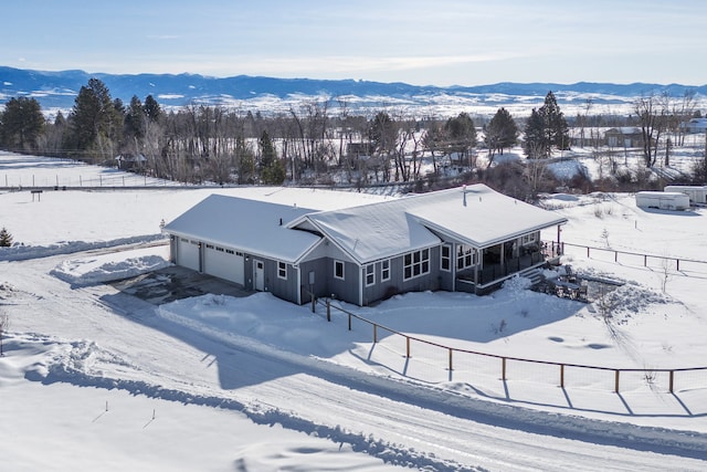 snowy aerial view featuring a mountain view