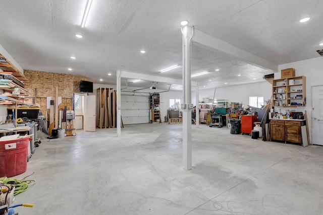 garage featuring a workshop area and recessed lighting