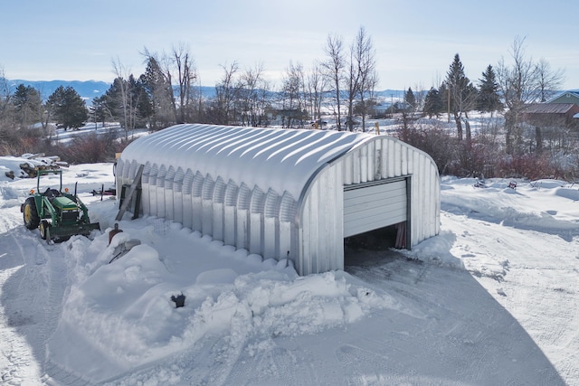 exterior space with a garage and an outbuilding