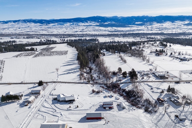 snowy aerial view featuring a mountain view