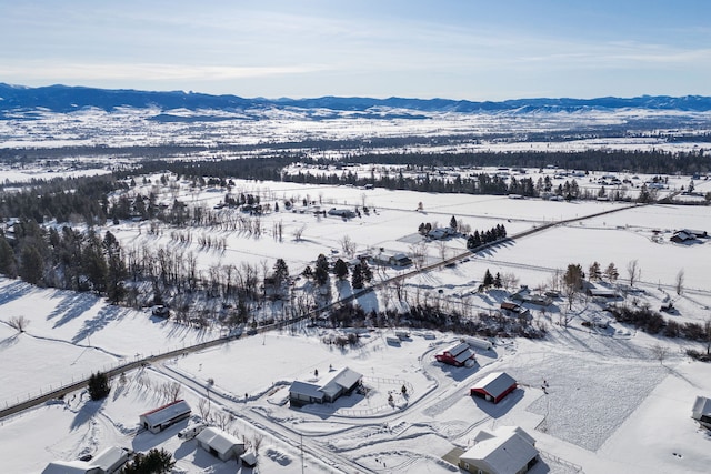 snowy aerial view featuring a mountain view