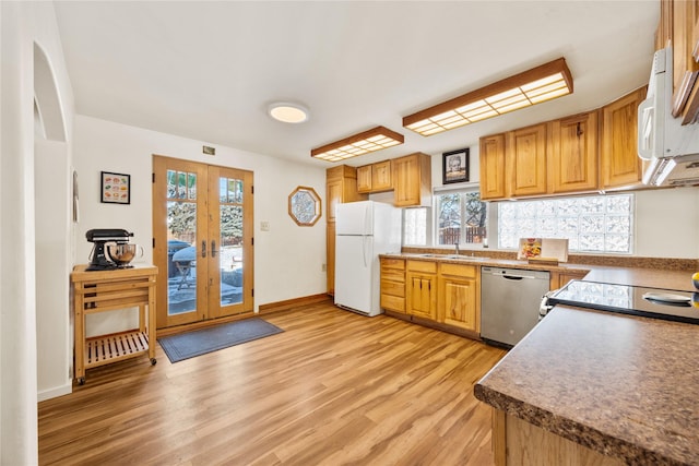 kitchen with light wood-style flooring, stove, french doors, stainless steel dishwasher, and freestanding refrigerator