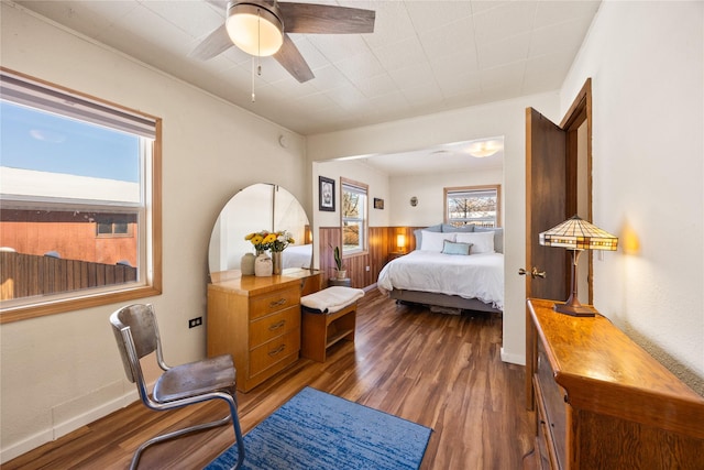 bedroom with ceiling fan, dark wood-style flooring, and baseboards