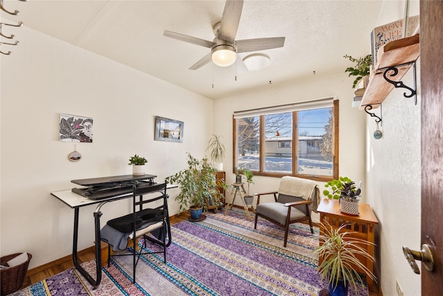 home office featuring baseboards, a textured ceiling, a ceiling fan, and wood finished floors