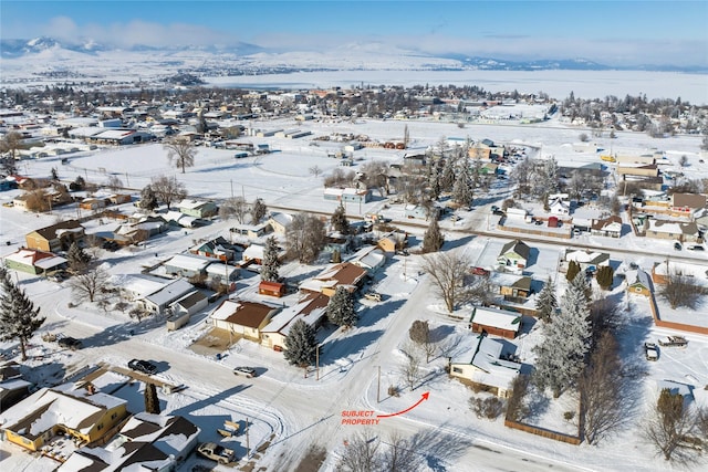 snowy aerial view featuring a residential view