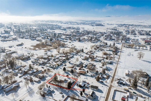 snowy aerial view with a residential view