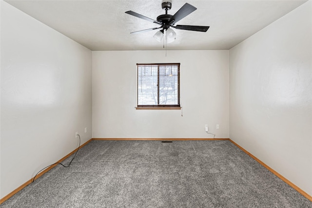 empty room with carpet, baseboards, and ceiling fan