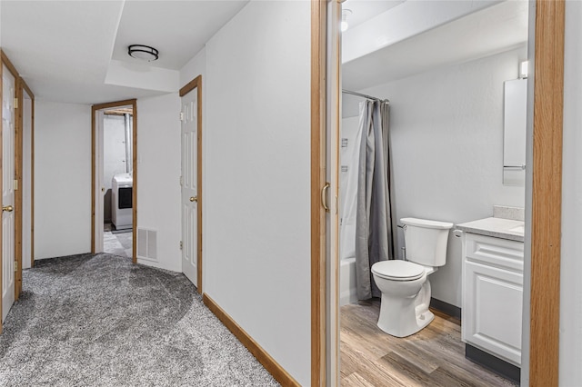 full bath featuring toilet, shower / tub combo, wood finished floors, visible vents, and vanity