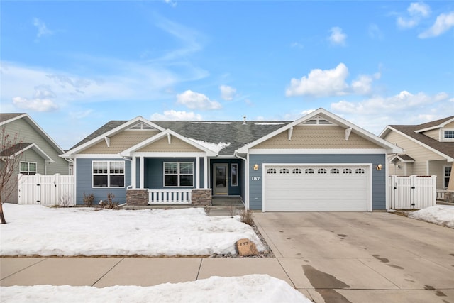 craftsman house with a garage, driveway, a porch, and a gate