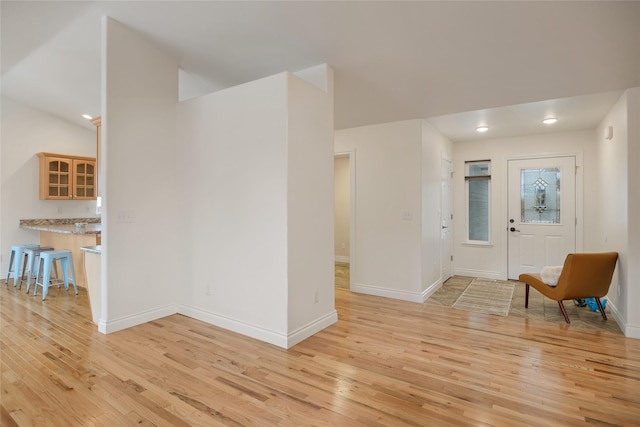 foyer with baseboards, recessed lighting, and light wood-style floors