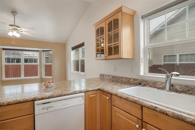 kitchen featuring light countertops, glass insert cabinets, vaulted ceiling, white dishwasher, and a sink