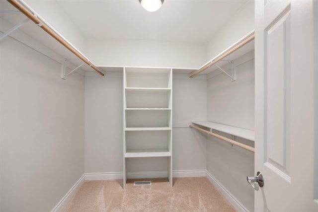 spacious closet with light carpet and visible vents