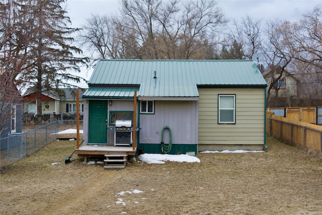 exterior space featuring a fenced backyard and metal roof