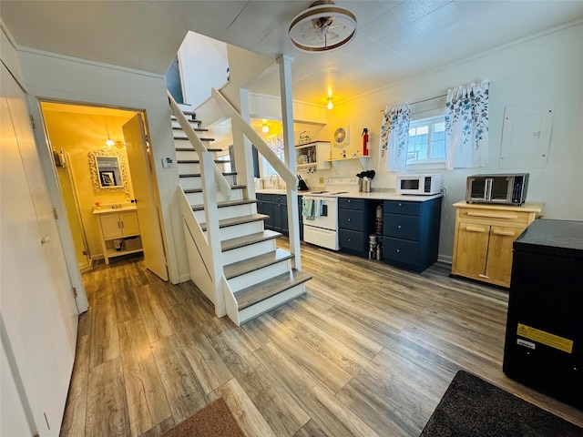 kitchen featuring white appliances, a toaster, light countertops, and light wood-style floors