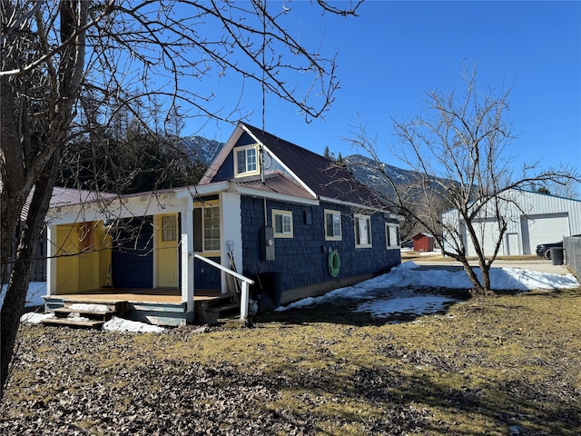 bungalow with metal roof and an outdoor structure