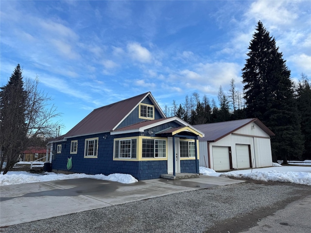 view of front of property with metal roof and an outdoor structure