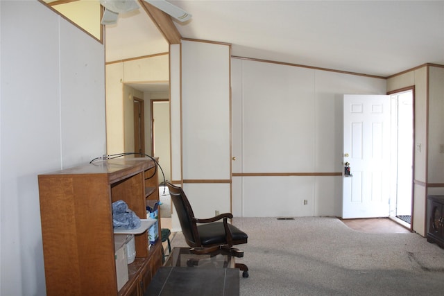 carpeted home office featuring lofted ceiling, ceiling fan, and crown molding