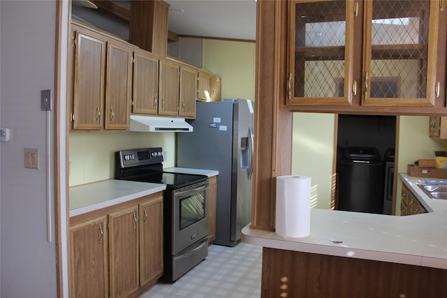 kitchen featuring washer and clothes dryer, light floors, light countertops, appliances with stainless steel finishes, and under cabinet range hood