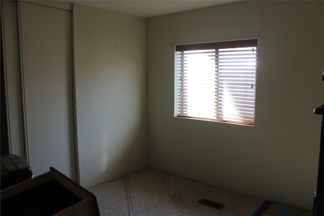 empty room with speckled floor and visible vents