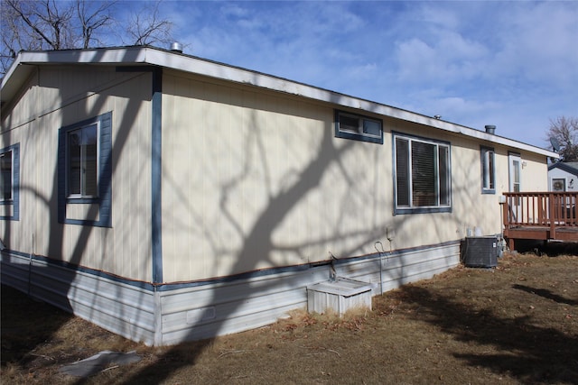 view of property exterior with a deck and cooling unit