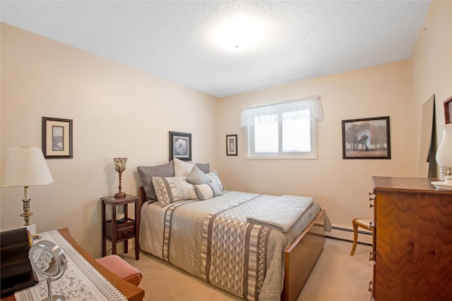 bedroom with a baseboard heating unit, light carpet, and a textured ceiling