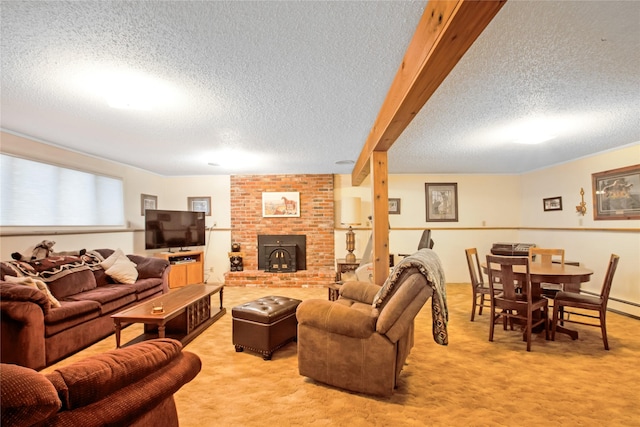 living area with beamed ceiling, a textured ceiling, and light colored carpet