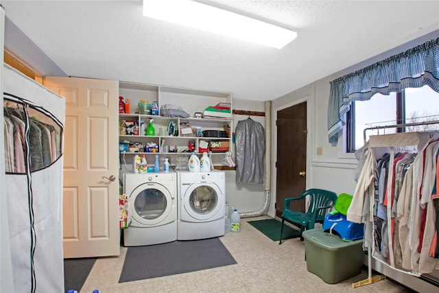 laundry room with a textured ceiling, separate washer and dryer, and tile patterned floors