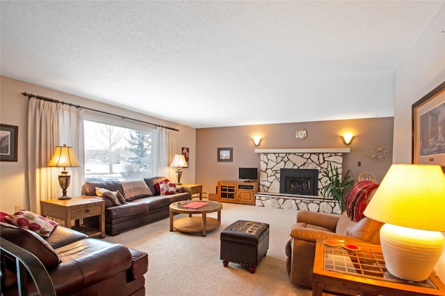 living room featuring a textured ceiling, a stone fireplace, and carpet flooring