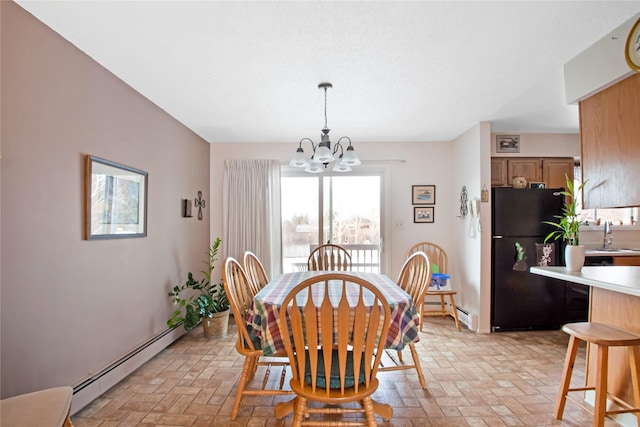 dining room featuring a baseboard heating unit, brick floor, and a notable chandelier