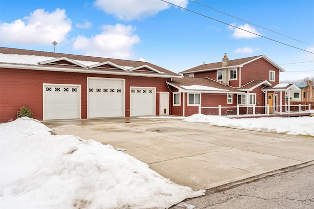 view of front of house featuring concrete driveway and an attached garage