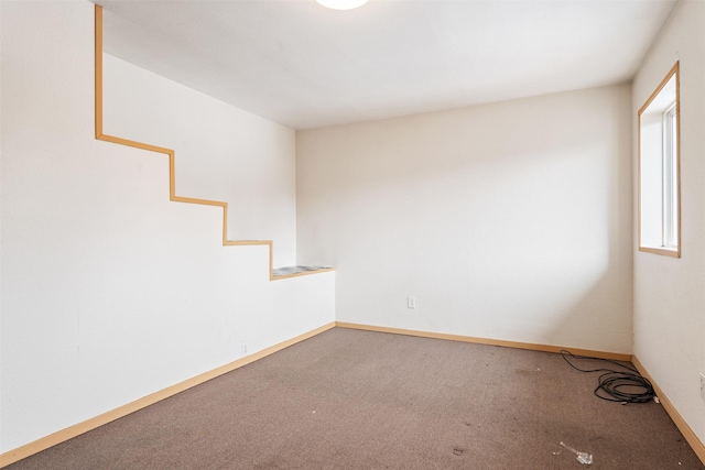 carpeted spare room with baseboards