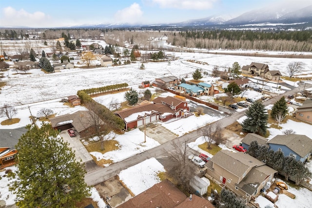 snowy aerial view featuring a residential view