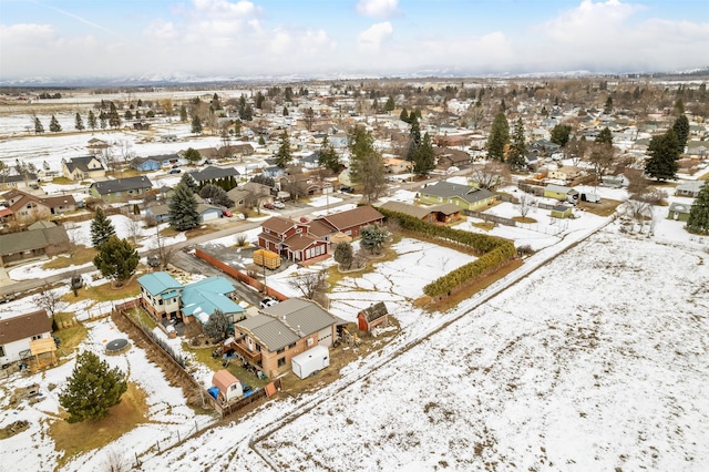 snowy aerial view featuring a residential view