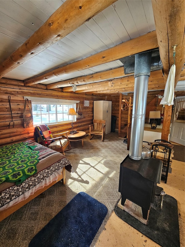 living area with wood ceiling, a wood stove, rustic walls, and beam ceiling