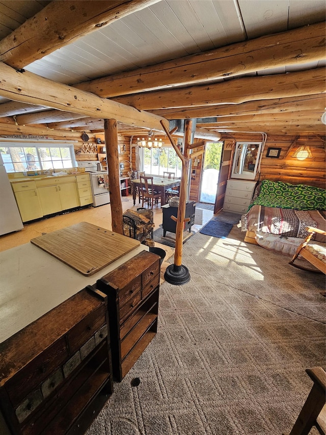 interior space featuring rustic walls, a wealth of natural light, and beamed ceiling