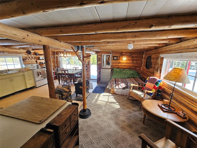 interior space with rustic walls, multiple windows, and beamed ceiling