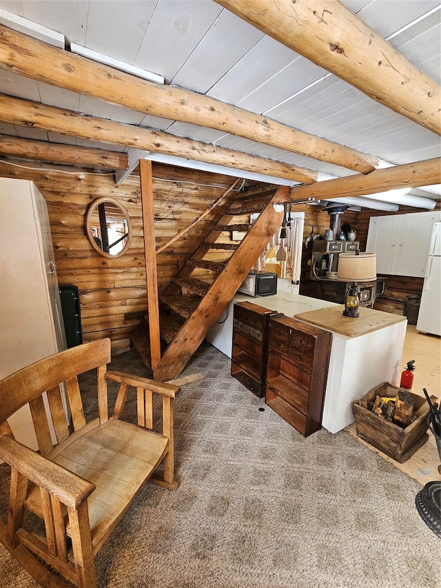 bar with beamed ceiling, freestanding refrigerator, log walls, carpet flooring, and black microwave