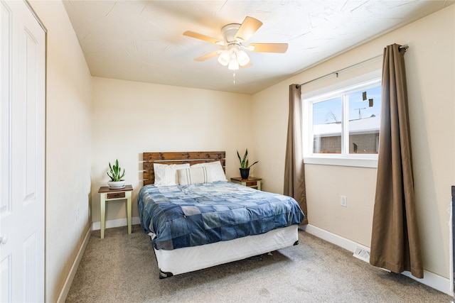 carpeted bedroom featuring visible vents, ceiling fan, and baseboards