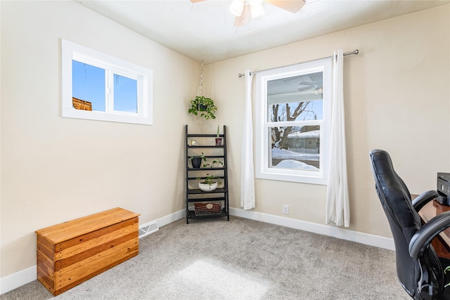 carpeted office space with ceiling fan, visible vents, and baseboards