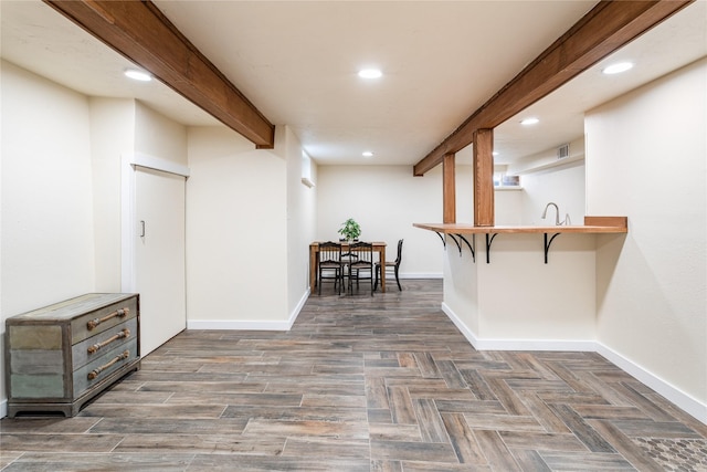 interior space featuring baseboards, parquet flooring, beam ceiling, and recessed lighting