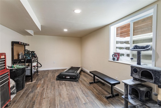 exercise area with dark wood-style flooring, recessed lighting, and baseboards