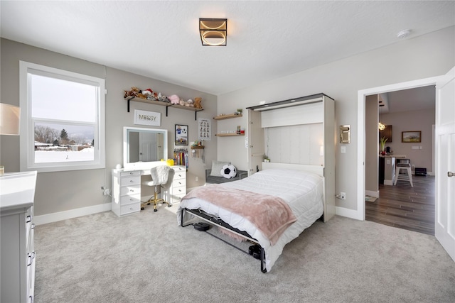 bedroom with carpet floors and baseboards