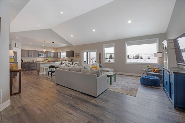 living area featuring dark wood-style floors, recessed lighting, high vaulted ceiling, and baseboards